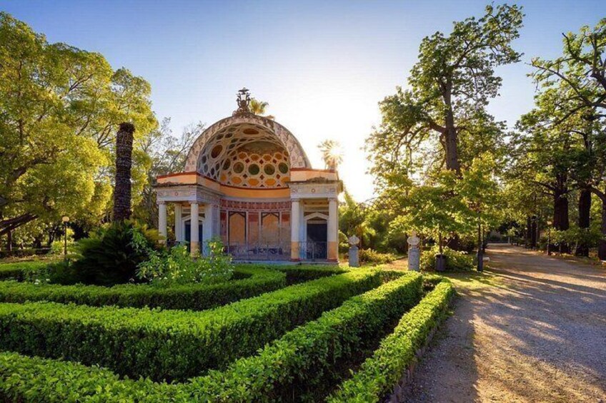 A domed building with a garden in front. 2