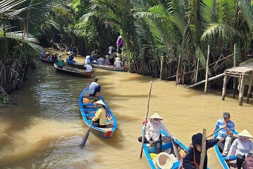 A river with boats, people, and a wooden structure. 1