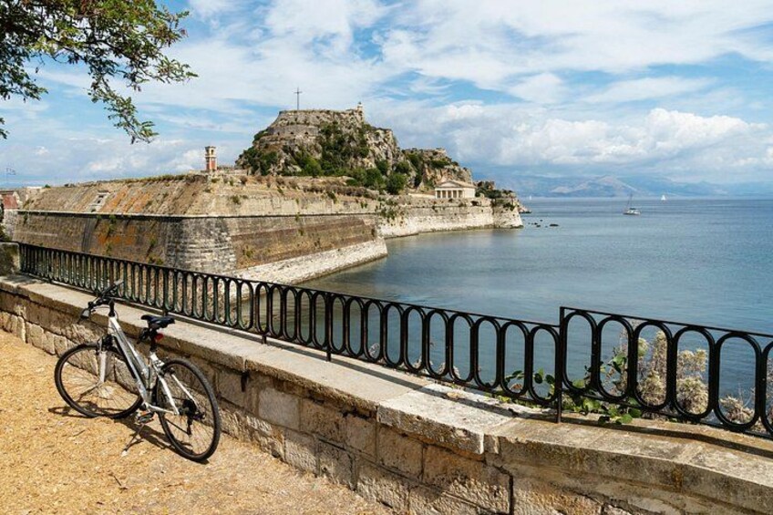 A coastal fortification with a bicycle leaning against a stone wall. 3
