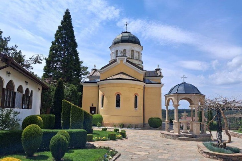 A church with a dome and a bell tower, surrounded by well-manicured gardens and a gazebo. 2