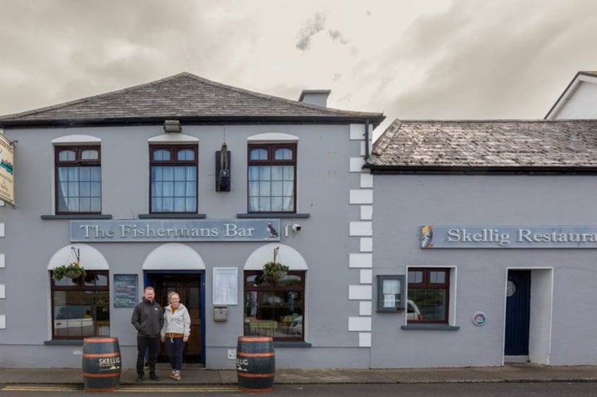 The Fisherman's Bar and Skellig Restaurant with a grey facade and arched windows. 4
