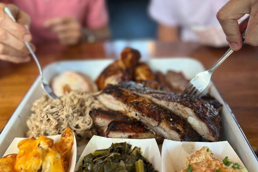 A meal with grilled meat, a side of greens, and a baked potato. 2