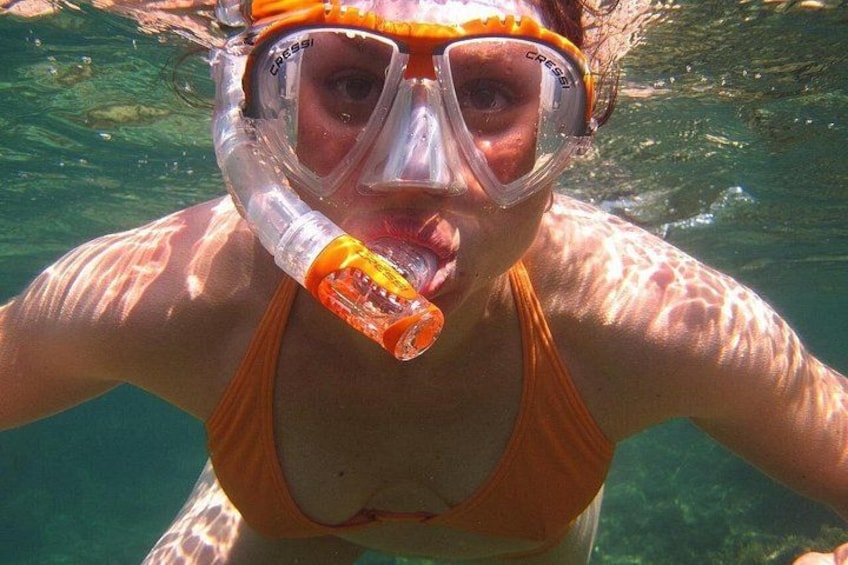 A person snorkeling underwater with a snorkel and mask. 3