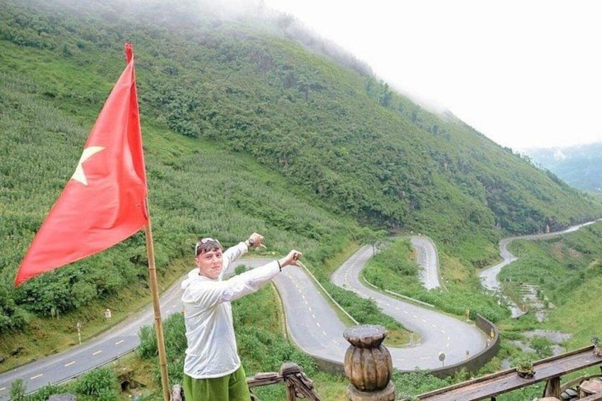 A winding road through a mountainous landscape with a red flag. 4