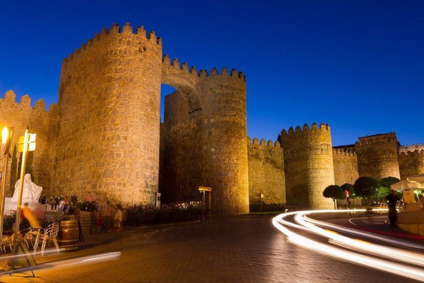 A historic stone castle with large towers and a moat. 5