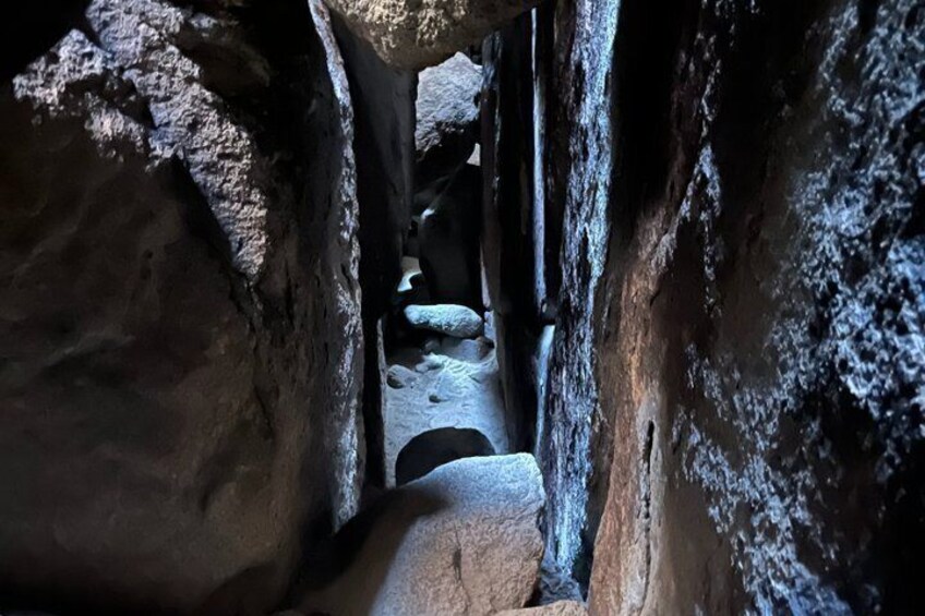 A narrow rock passage with a stone pathway. 3