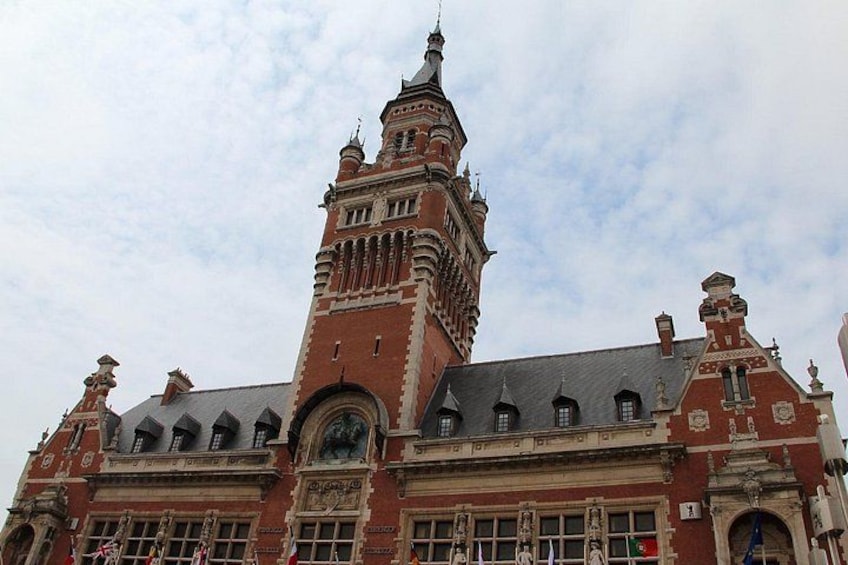 A historic building with a prominent tower and detailed facade. 3