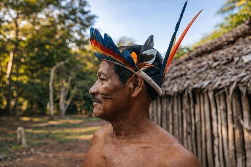Bora heritage: local elder with ceremonial headdress and cultural pride. 5