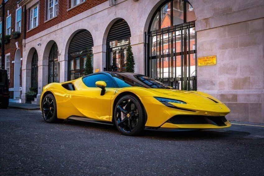 A yellow sports car parked on a street with a building in the background. 5