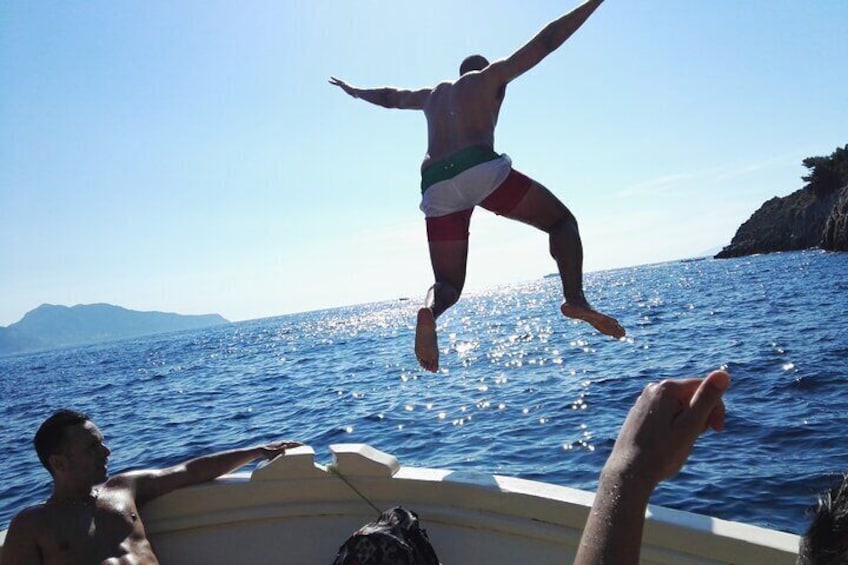 A person jumping off a boat into the sea. 5