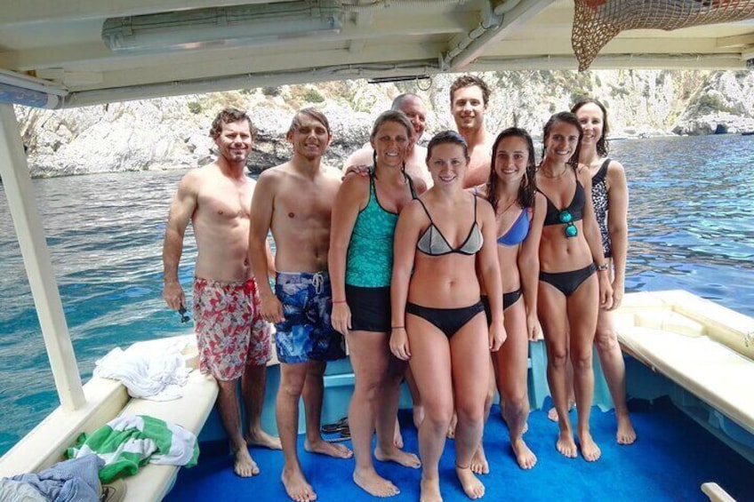 A group of people on a boat near rocky cliffs. 3