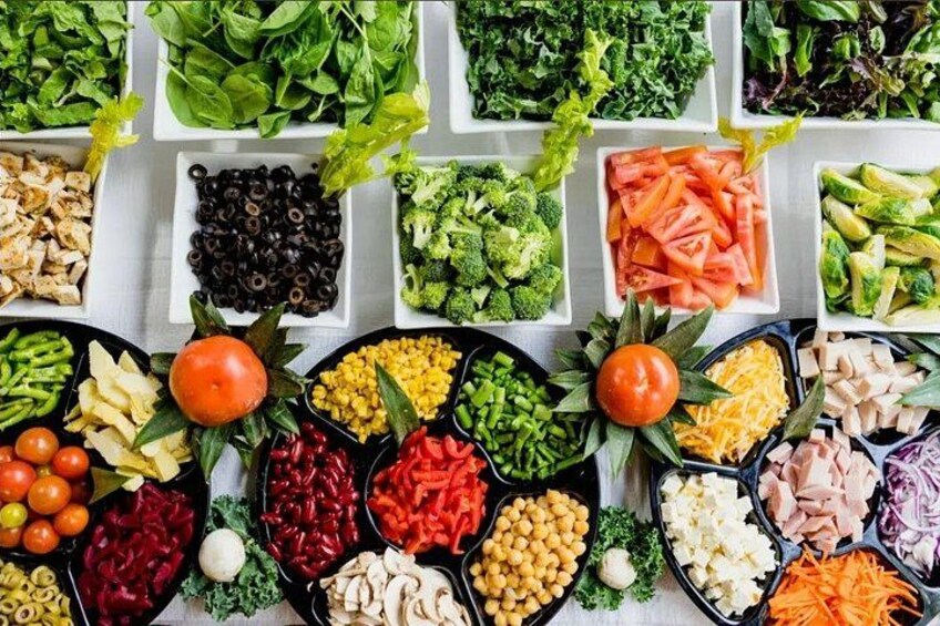 A variety of fresh vegetables and fruits arranged in trays. 2