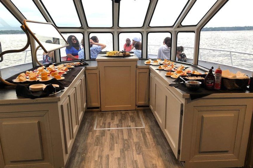 A boat kitchen with wooden cabinets and a central island. 3