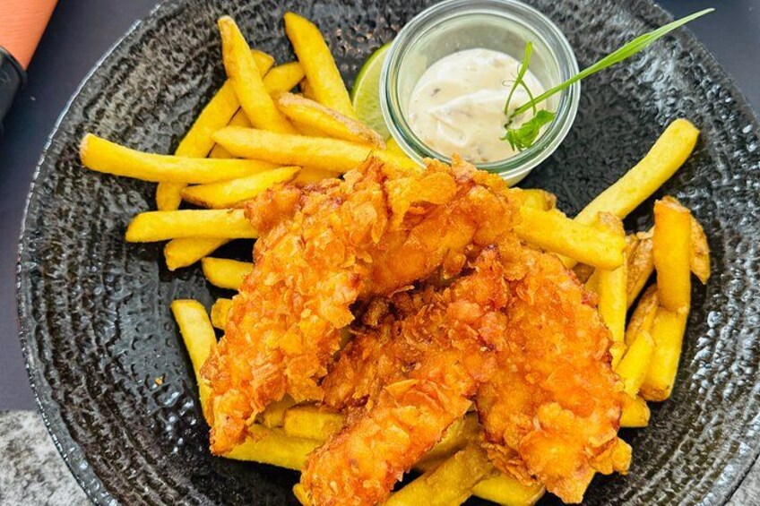 Pomfritter og stegt kylling anrettet på tallerken med tilhørende dip. 4