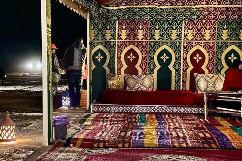 A traditional tent with intricate patterns and a colorful carpet. 5