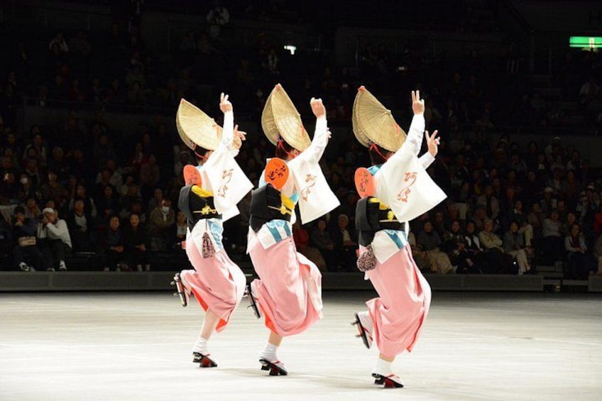 A traditional dance performance with performers in colorful costumes and fans. 1