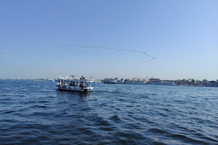 A body of water with boats and a distant shoreline. 3