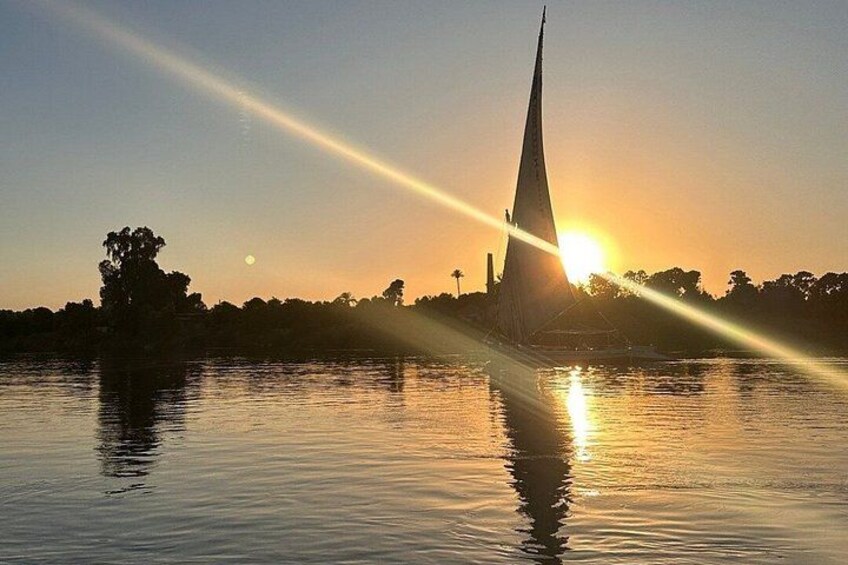 Luxor sunset sailboat smile 1