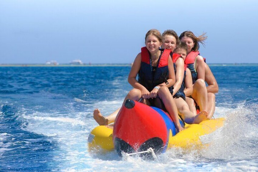 People on a watercraft with a red and yellow front. 5