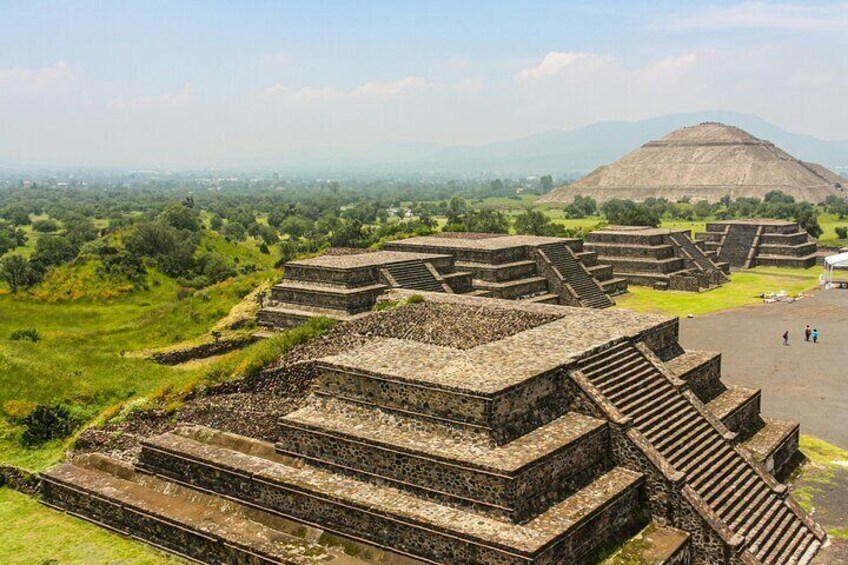 Ancient stepped pyramids with a large pyramid in the background. 1