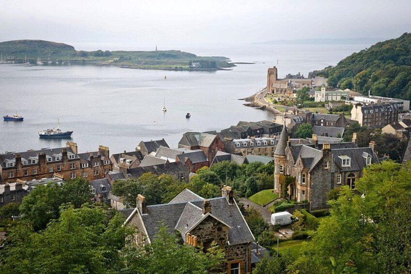 A coastal town with historic buildings, a church, and boats on the water. 5