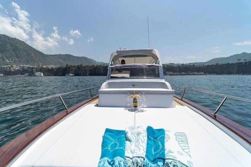 A boat on calm water with a mountainous landscape in the background. 2