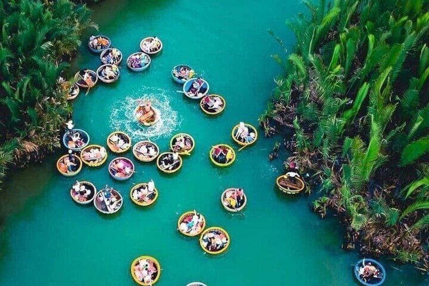 A group of people in small boats on a turquoise river surrounded by lush greenery. 4