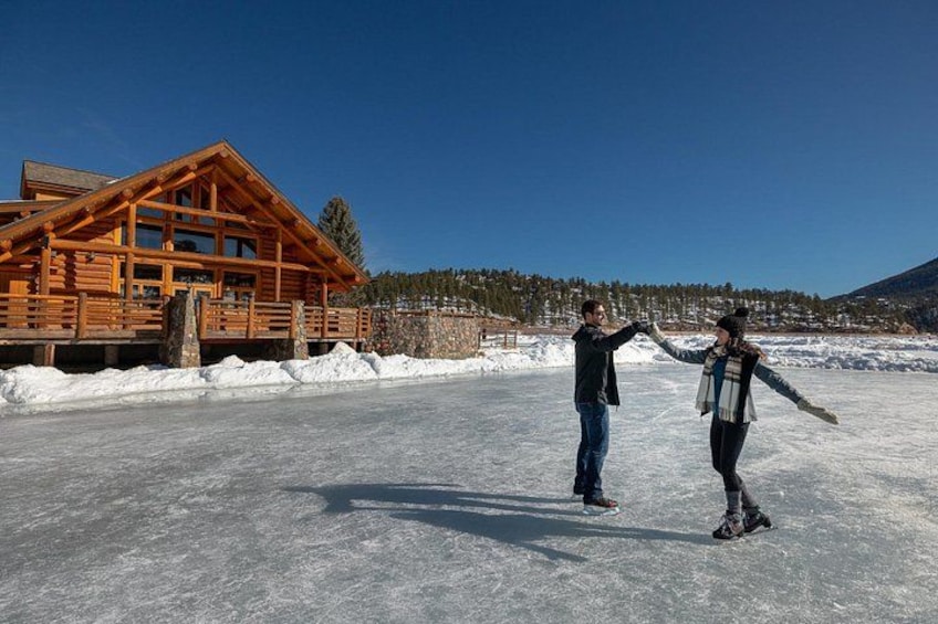 A wooden cabin, a snowy landscape, and two people holding hands. 1