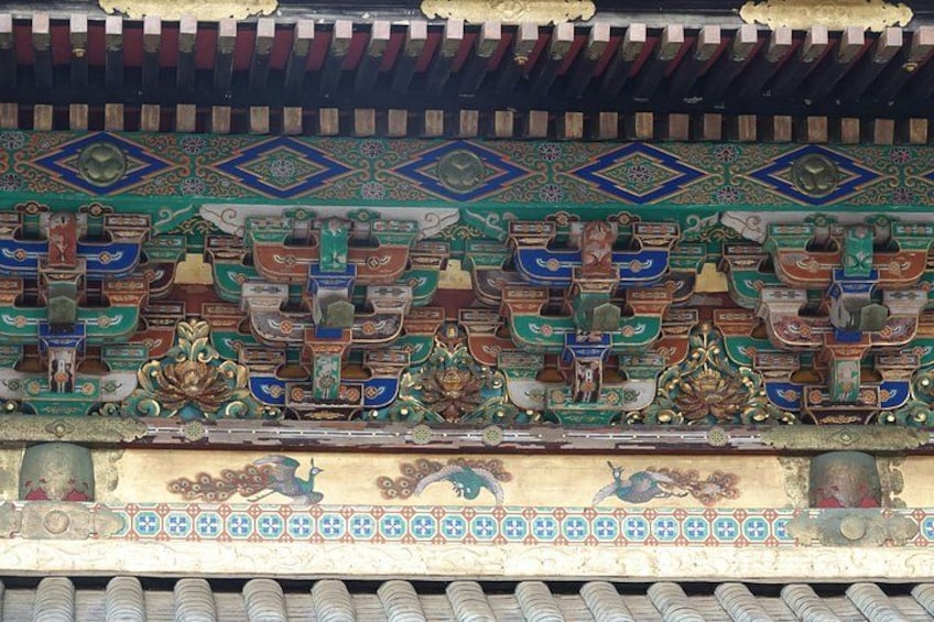 A traditional roof with ornate decorations, including colorful tiles and intricate patterns. 5