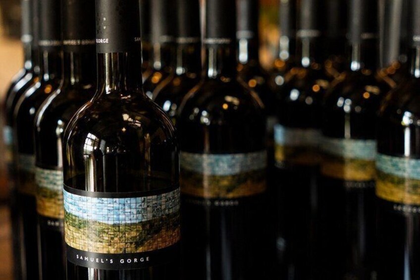 A row of wine bottles with labels. 4