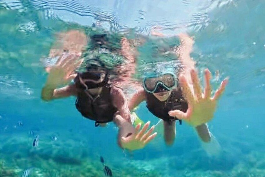 Two people swimming underwater. 1