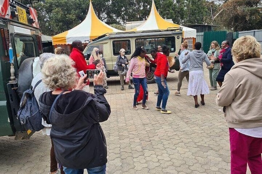A group of people gathered around a food truck with yellow and white tents in the background. 2