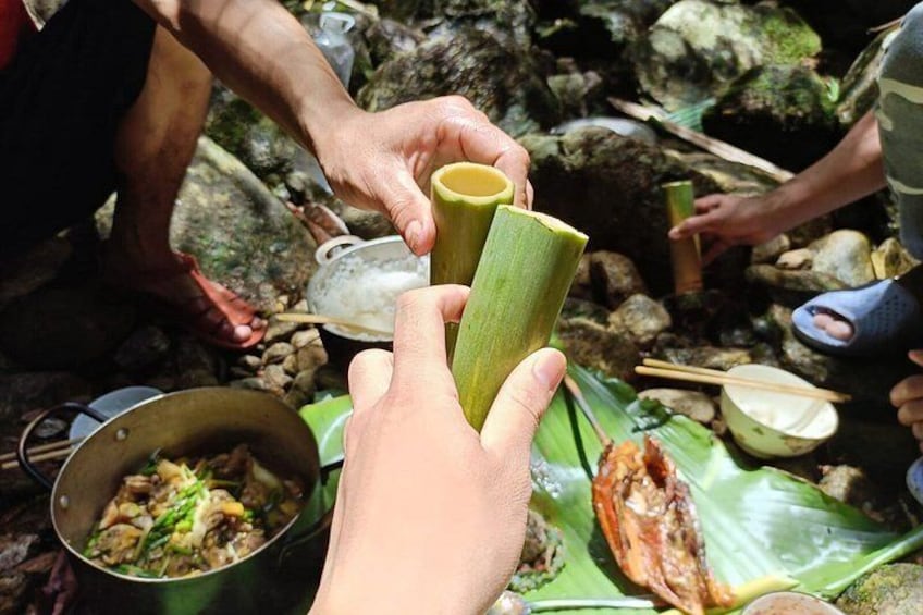 People holding green leaves, cooking food, and eating with bowls and chopsticks. 3