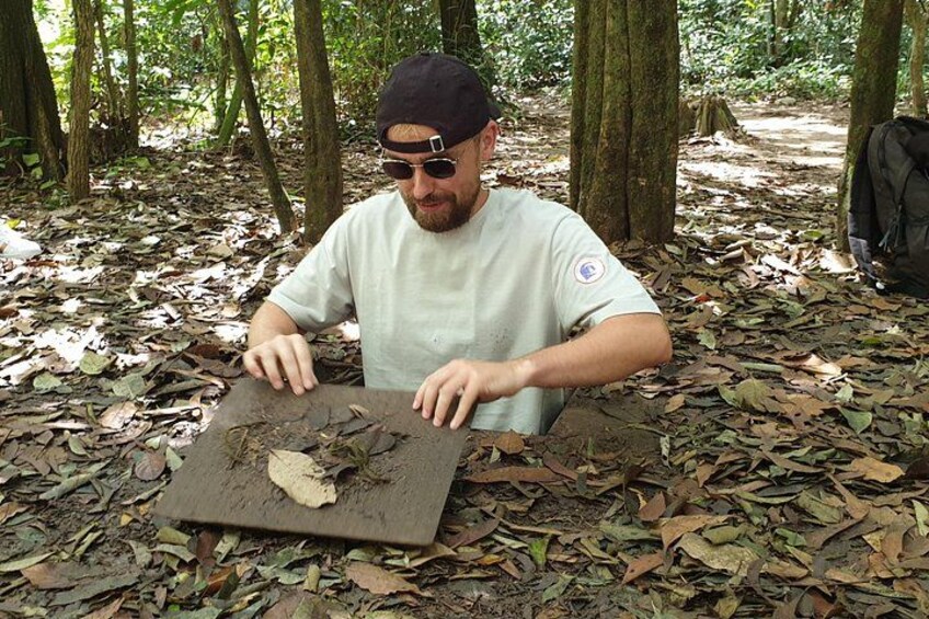 A person sitting on the forest floor with a flat surface in front of them. 2