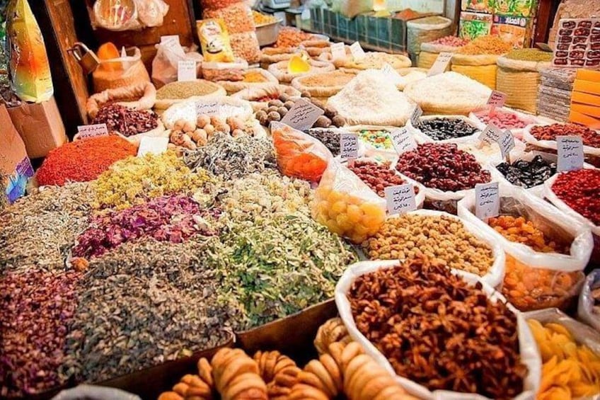 A market stall with various spices and dried goods. 2