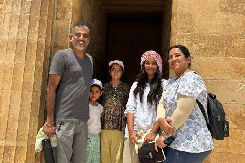 A family standing in front of a stone building with columns. 2