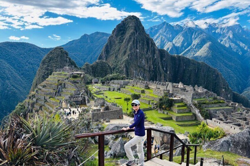 Machu Picchu with Inca stone structures, terraced fields, and steep mountain backdrop. 3