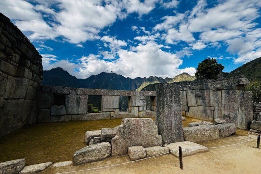 Ancient stone ruins with a mountainous backdrop. 5