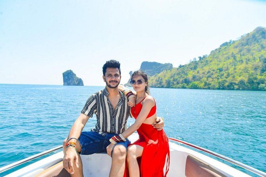 A couple on a boat with a mountainous landscape in the background. 1