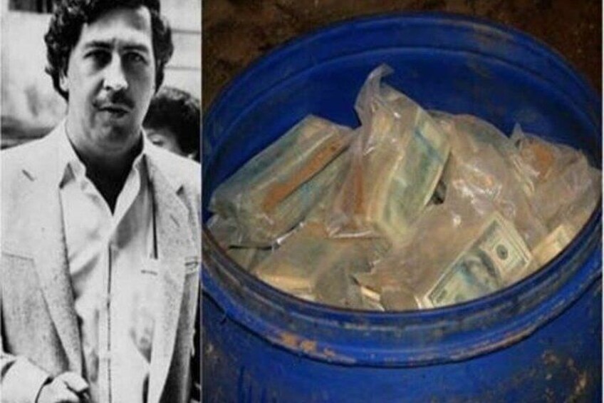 A man in a suit and a blue bucket filled with dollar bills. 4