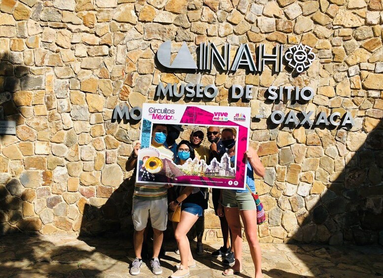 A stone wall with a sign for the Museo de Sitio. 1