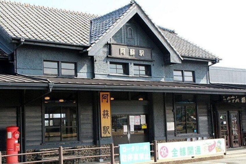 A traditional Japanese building with a dark facade and tiled roof. 2