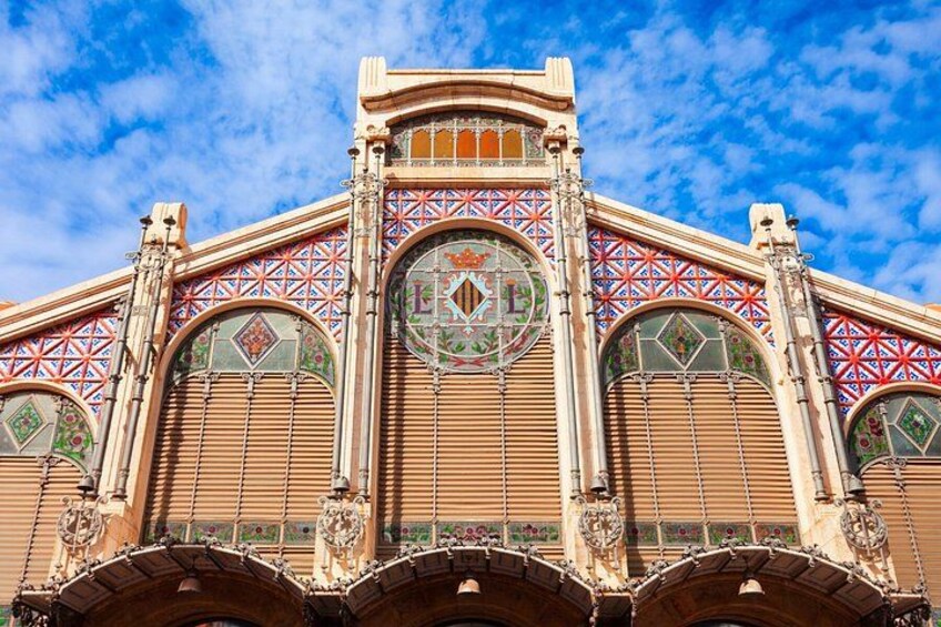 A building with ornate architectural details, including a large circular window and decorative arches. 2