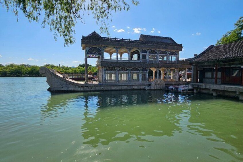 A traditional Chinese building with a boat-shaped structure on a river. 2