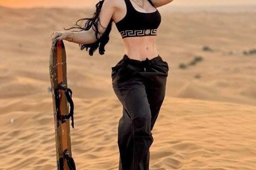 A person holding a surfboard in a desert landscape. 3