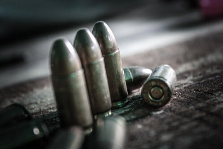 A close-up of bullets on a textured surface. 3