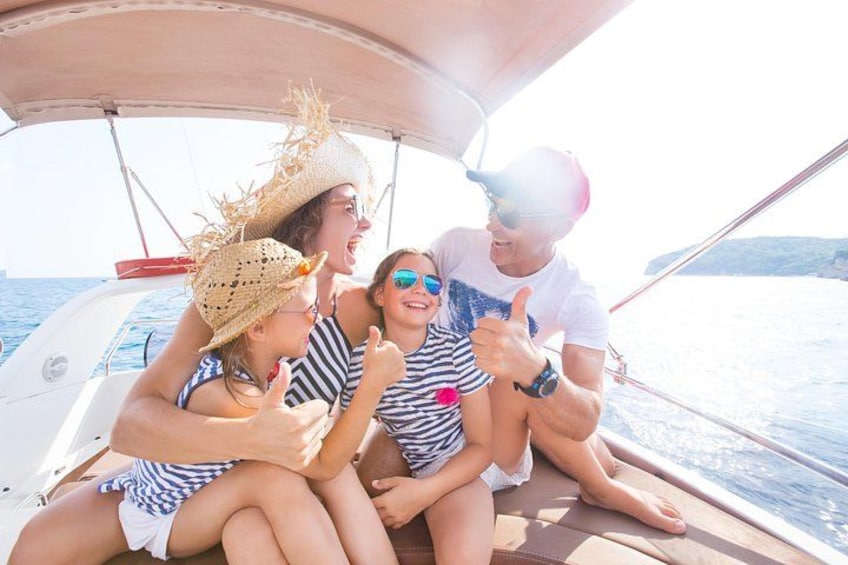 People on a boat, wearing hats and giving thumbs up. 5
