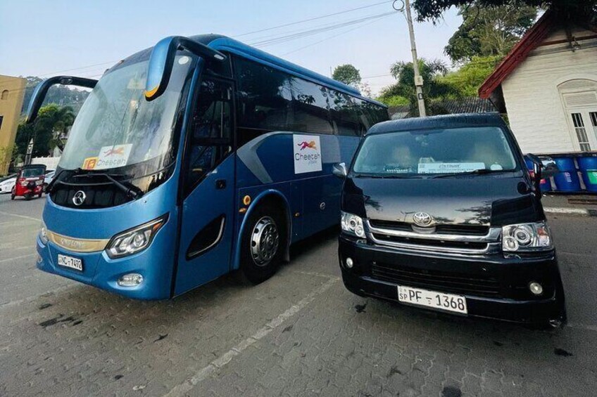 A blue bus and a black car parked on a street. 4