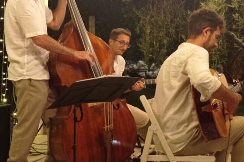 A group of musicians performing outdoors at night. 3