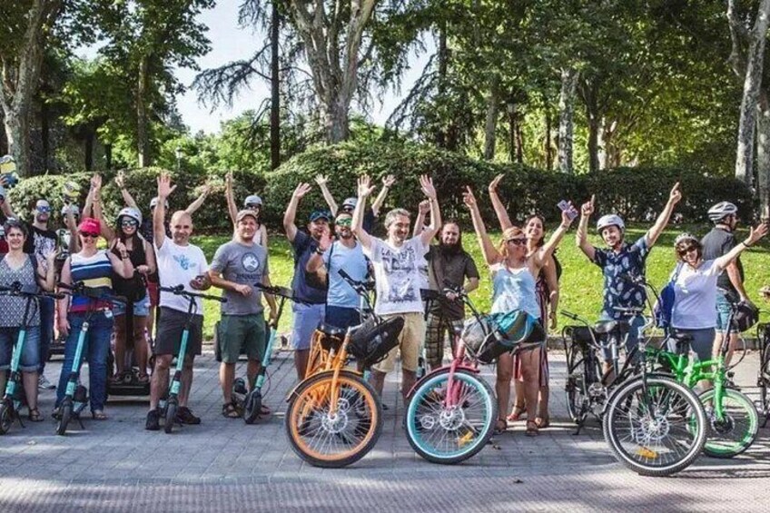 A group of people with bicycles in a park. 2